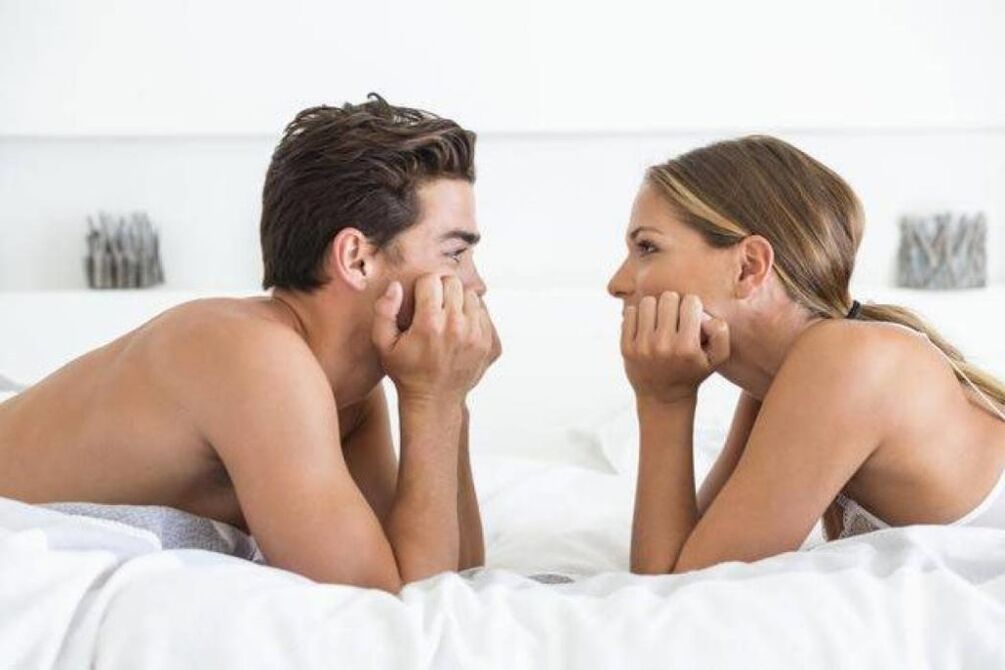 woman in bed with a man with an enlarged penis